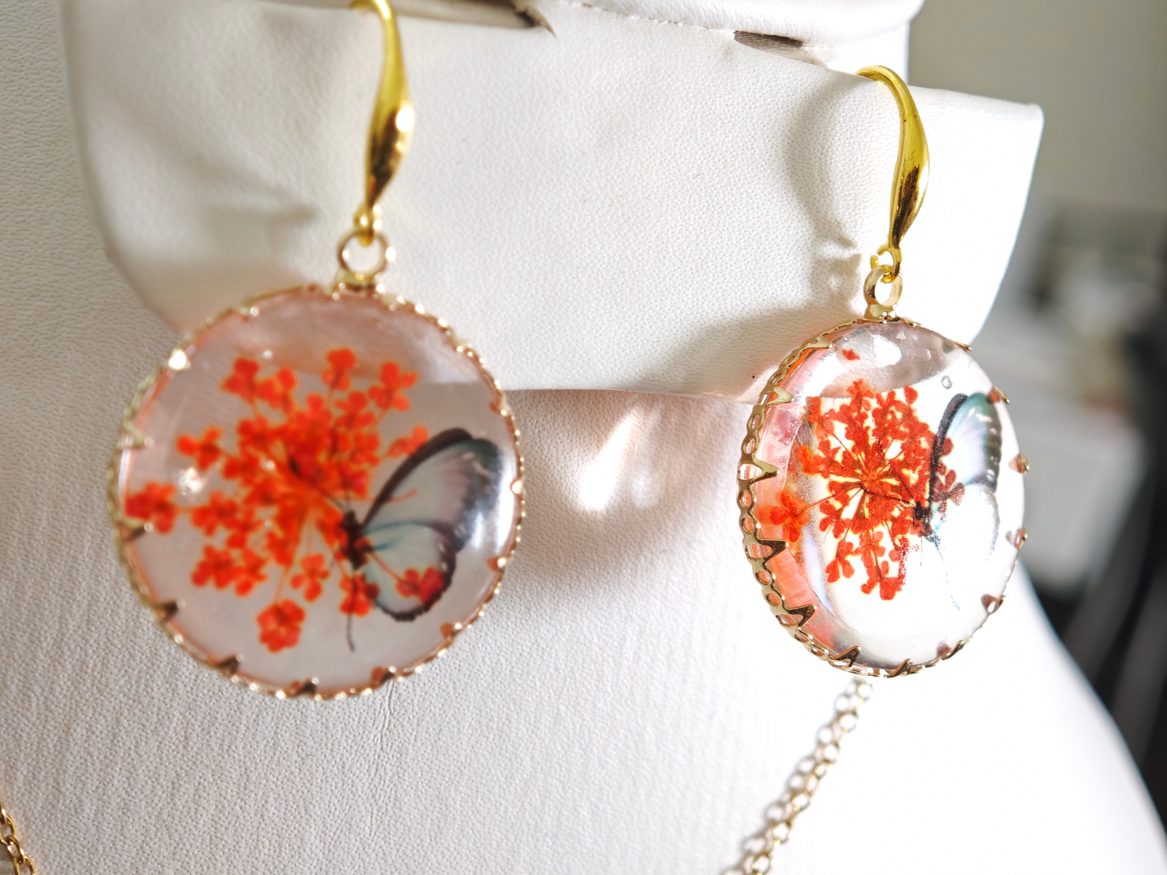 Sapraa Trends Unique Round Resin Earrings in Gold Mould with real flowers preserved in orange and White