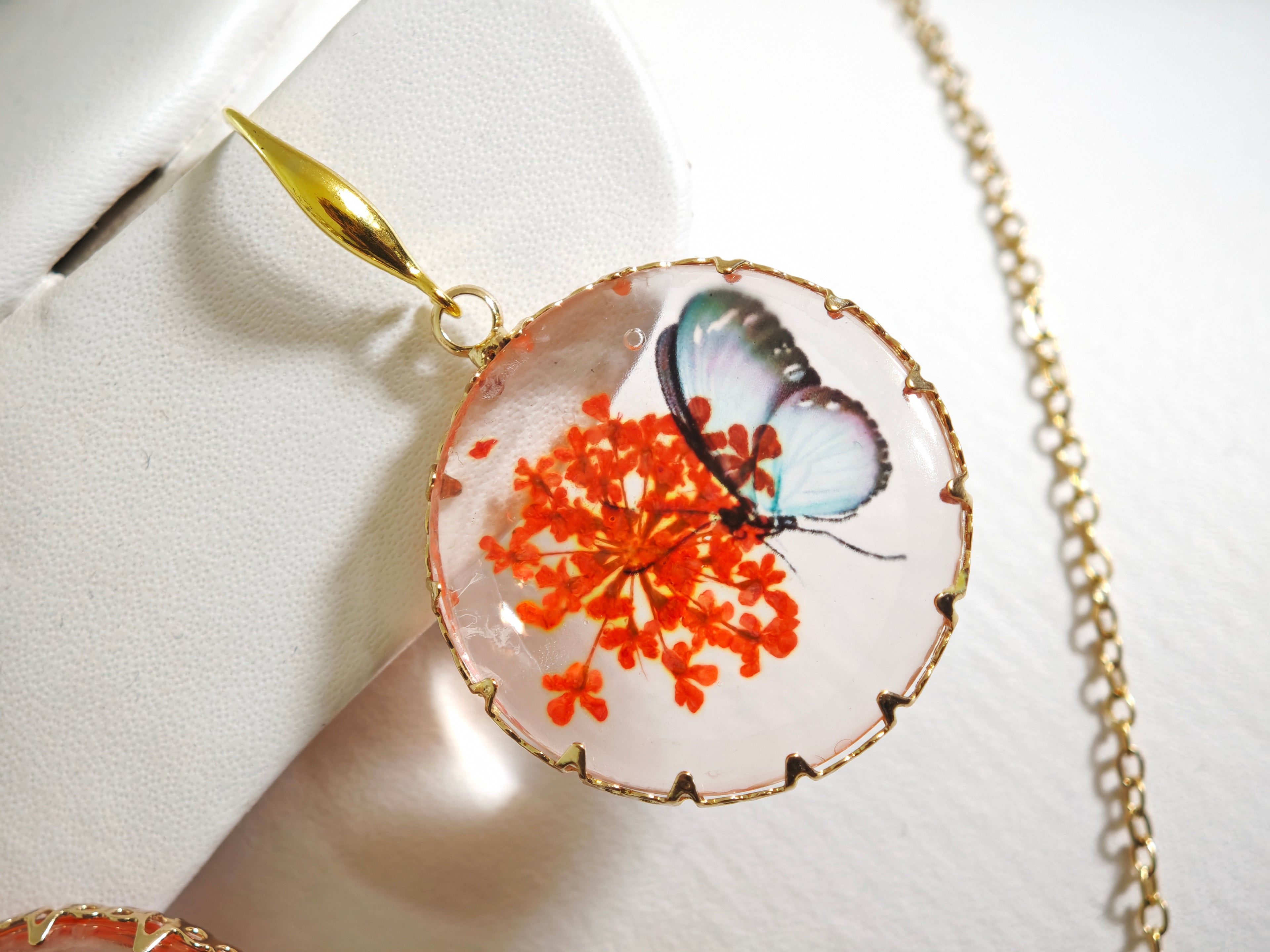 Sapraa Trends Unique Round Resin Earrings in Gold Mould with real flowers preserved in orange and White