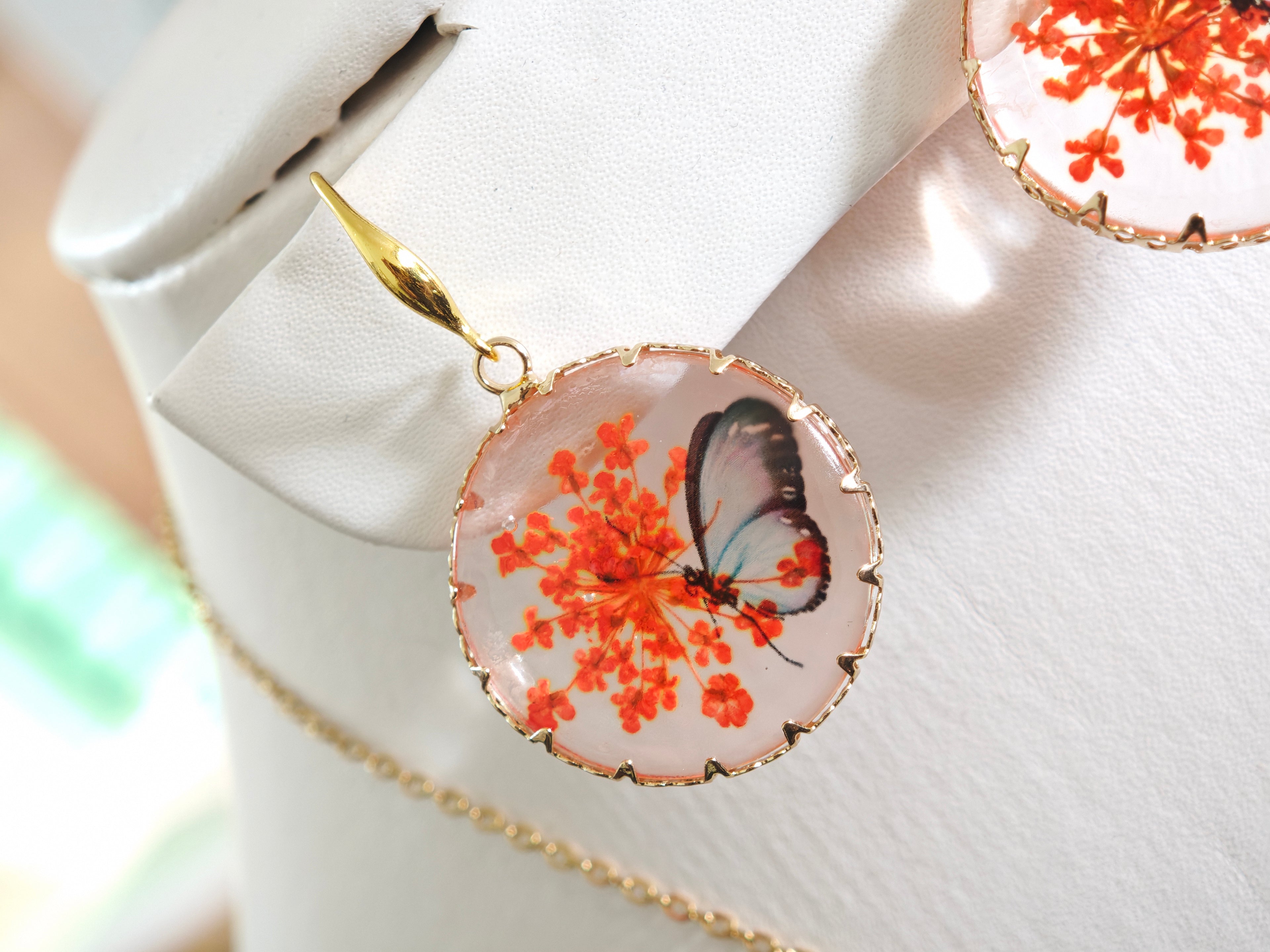 Sapraa Trends Unique Round Resin Earrings in Gold Mould with real flowers preserved in orange and White