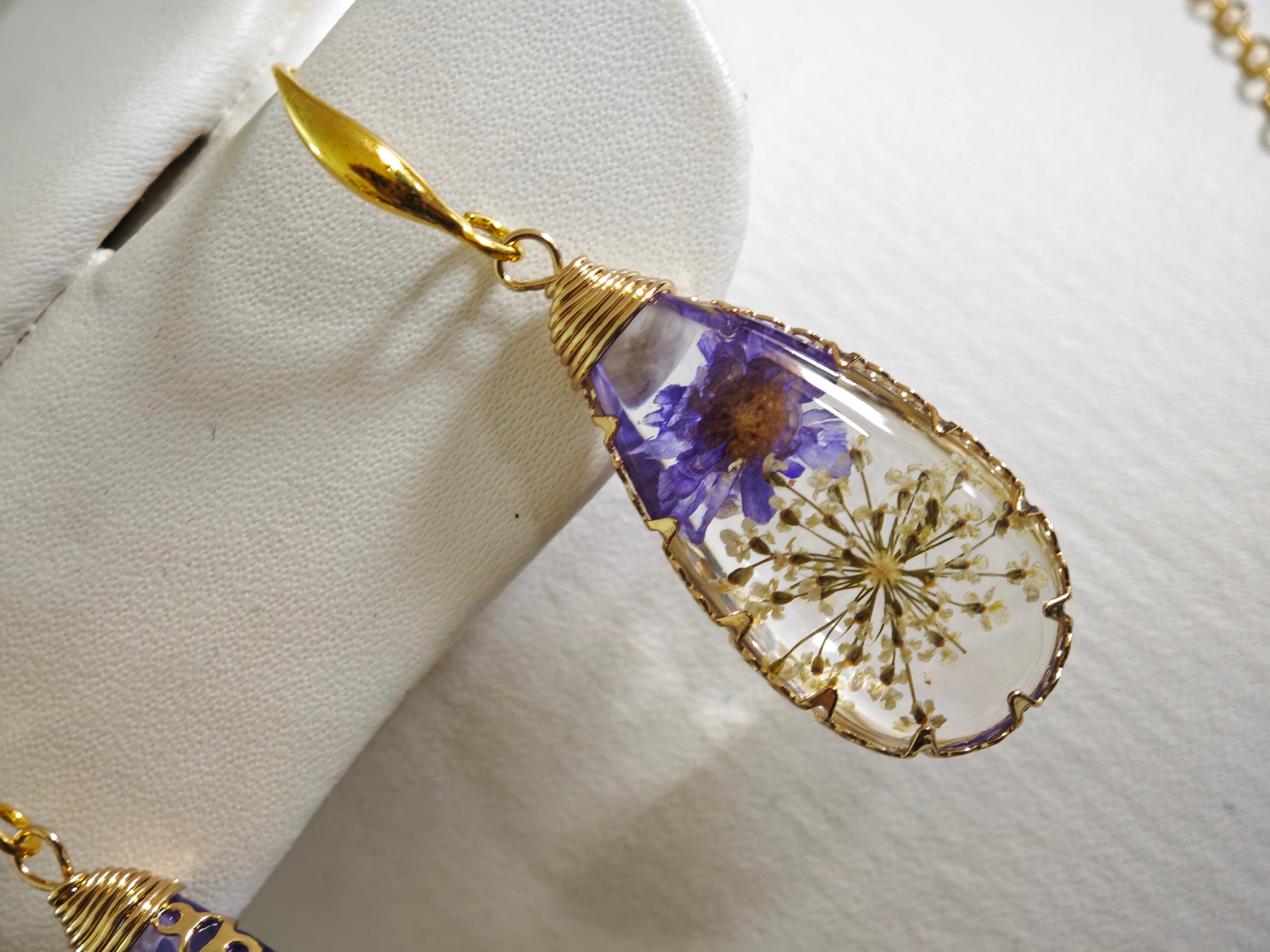 Sapraa Trends Unique Drop Resin Earrings in Gold Mould with real flowers preserved in white and purple