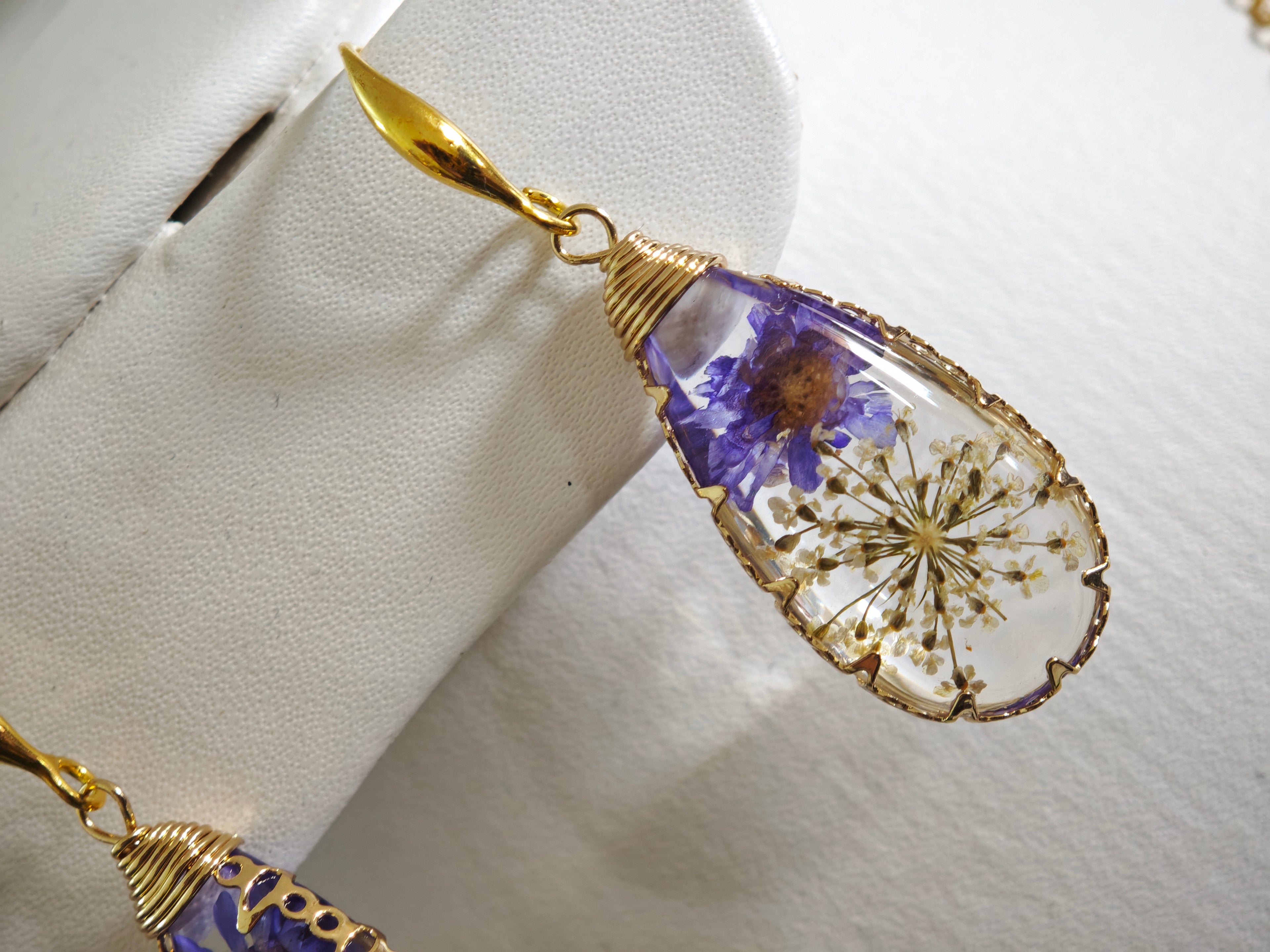 Sapraa Trends Unique Drop Resin Earrings in Gold Mould with real flowers preserved in white and purple